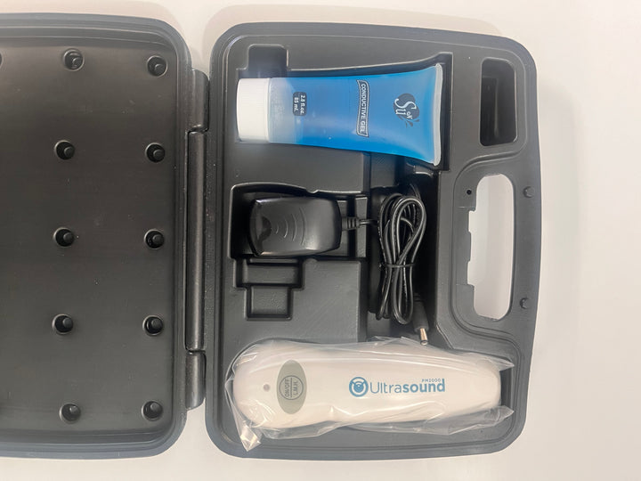 Portable Ultrasound PM 2000 device with AC adapter, gel, and carrying case.