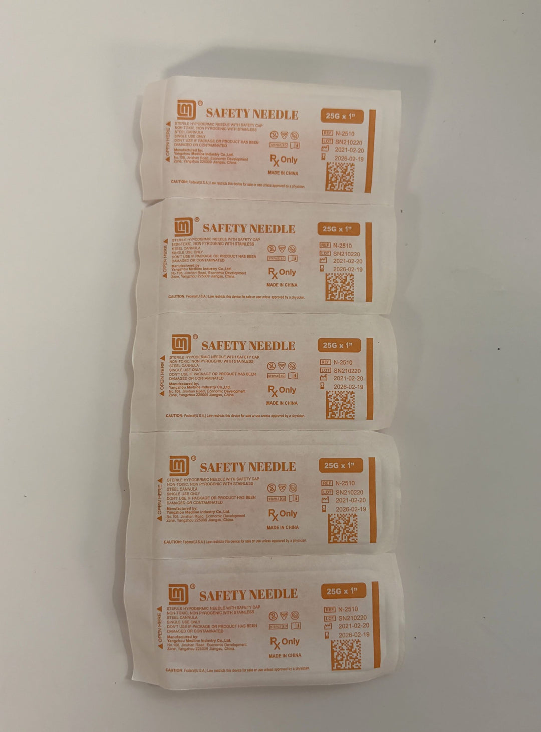 Five individually sealed sterile safety needles labeled with specifications and manufacturer information by Yangzhou Medline Industry, arranged vertically on a white surface.