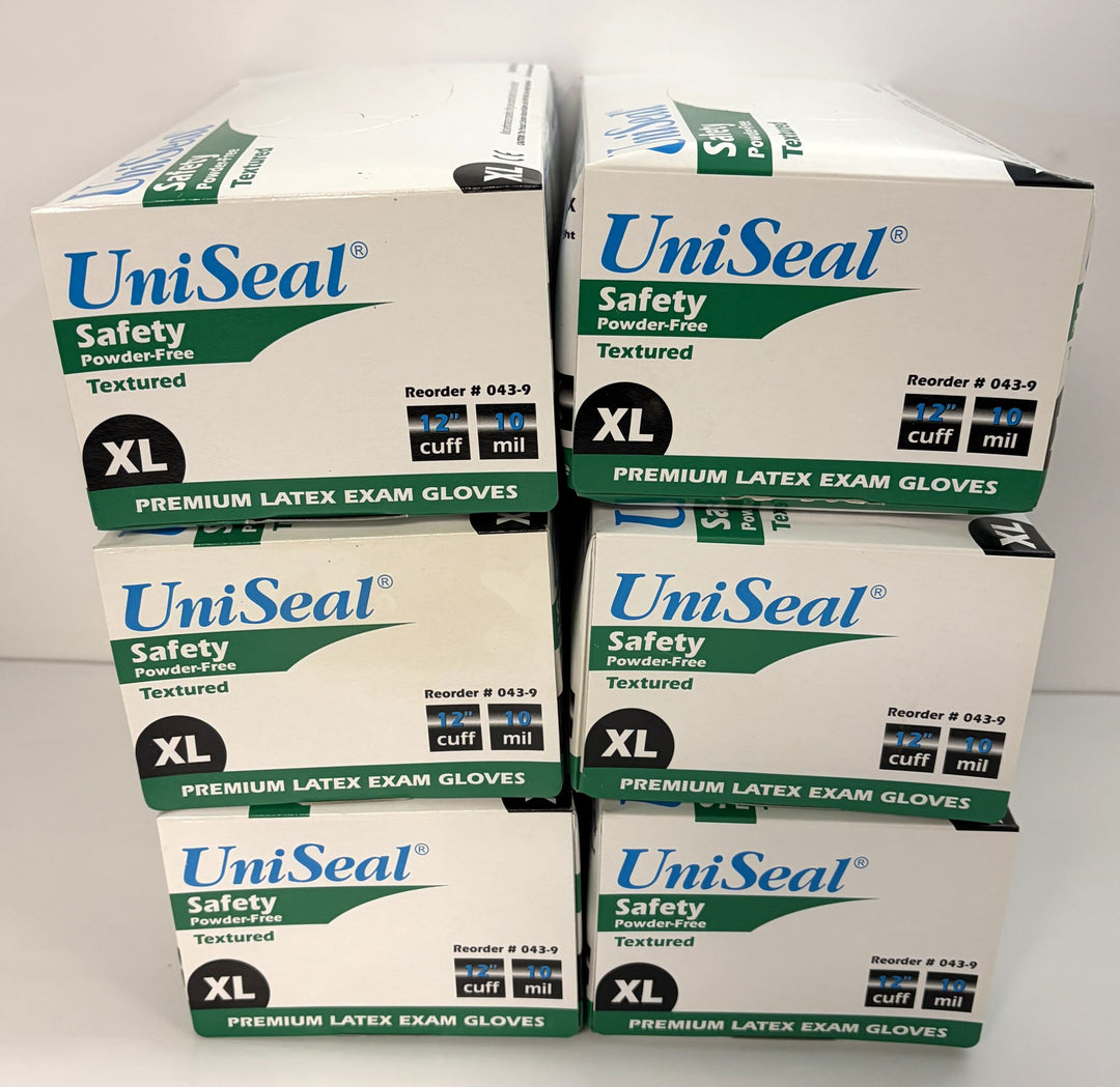 Stack of six white and green UniSeal boxes containing extra-large powder-free latex exam gloves with textured surface and extended cuff for safety and durability.