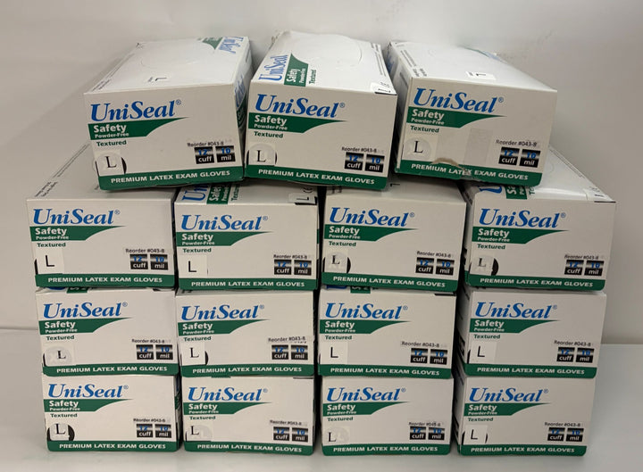 Stack of UniSeal Safety large premium textured latex exam gloves boxes arranged in multiple rows, displayed for wholesale or bulk purchase.