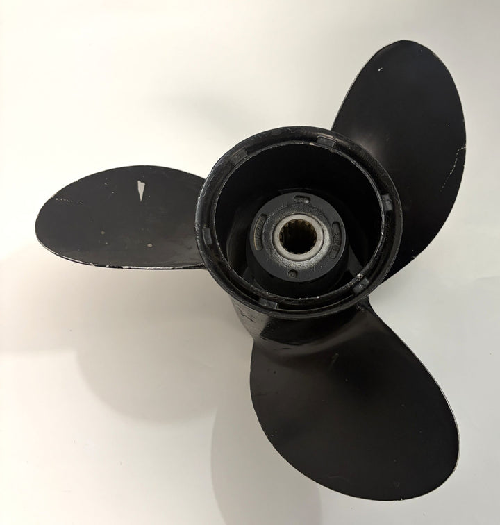 Black aluminum boat propeller with three blades and central spline hub, showing minor wear, suitable for Volvo marine drives in industrial or marine equipment use.