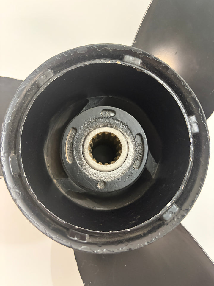 Close-up view of the internal 19-spline hub and mounting section of a Volvo aluminum boat propeller with visible blade edges and wear marks.