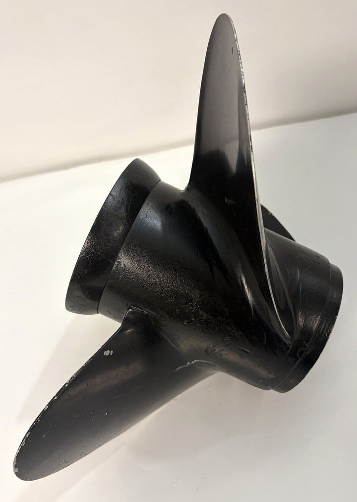 Black Volvo aluminum propeller with three curved blades and 19-spline drive hub, showing signs of use with minor scuffs on a white surface.