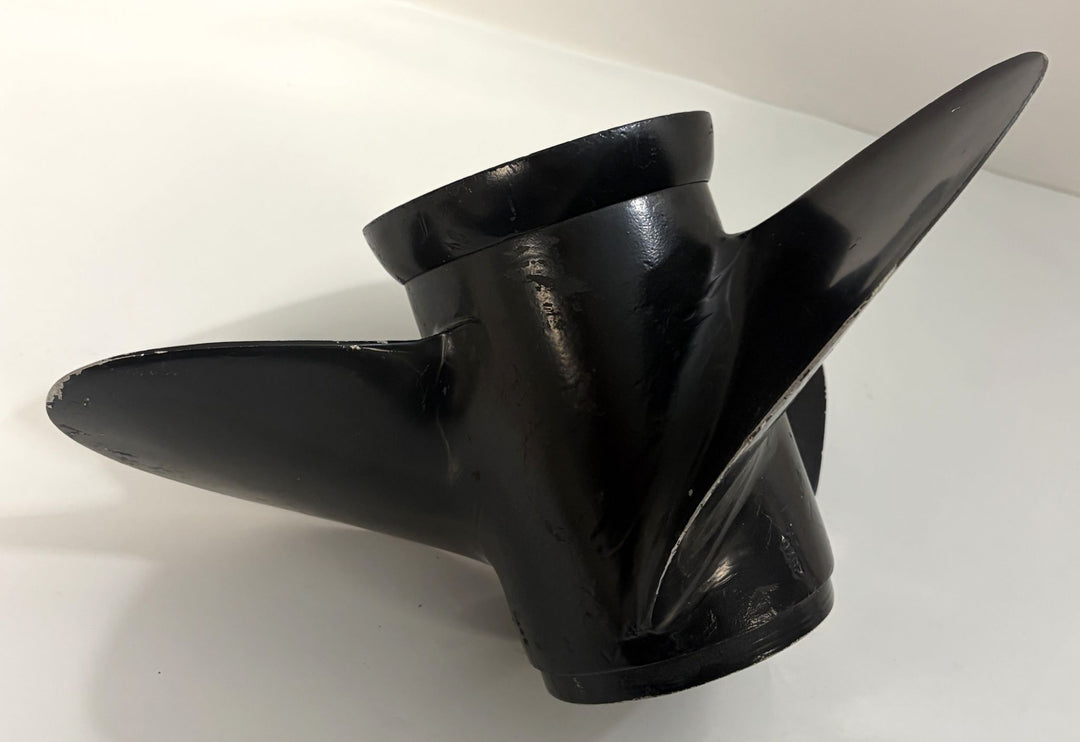 Black aluminum propeller with three blades and smooth finish, designed for marine use, compatible with Volvo engines and showing slight wear from prior use.