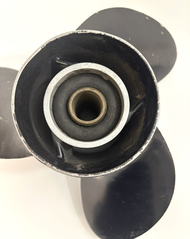 Close-up view of a pre-owned Volvo aluminum boat propeller showing the central 19-spline hub and three blades with some surface wear.