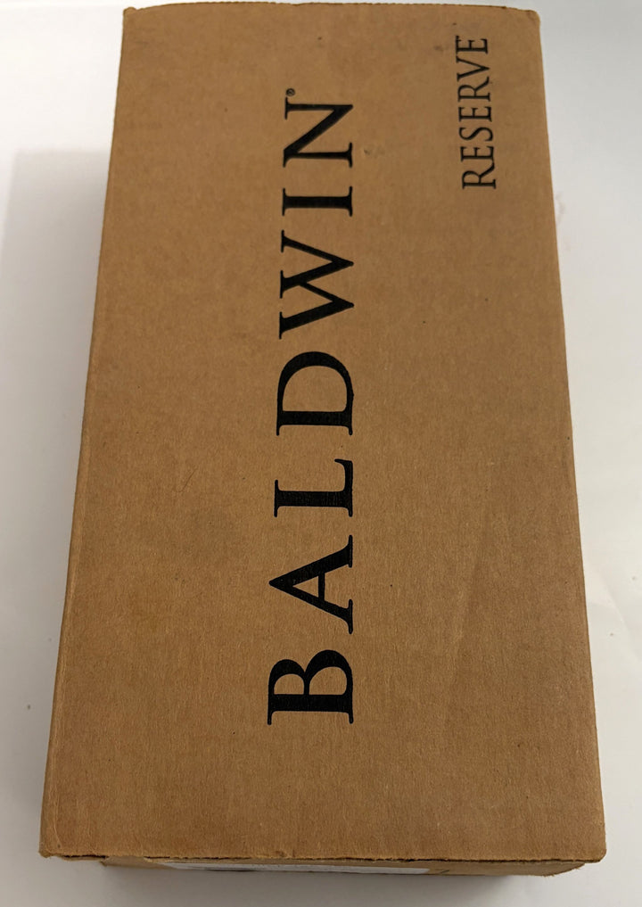 Brown cardboard box featuring the Baldwin Reserve logo printed in black, intended for premium hardware products from Baldwin.
