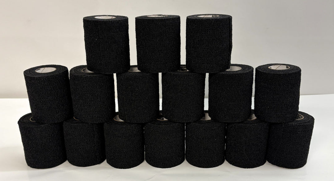 Stack of black self-adhering sports wrap rolls by Milliken, arranged in a pyramid on a white surface, suitable for athletic support and compression use.