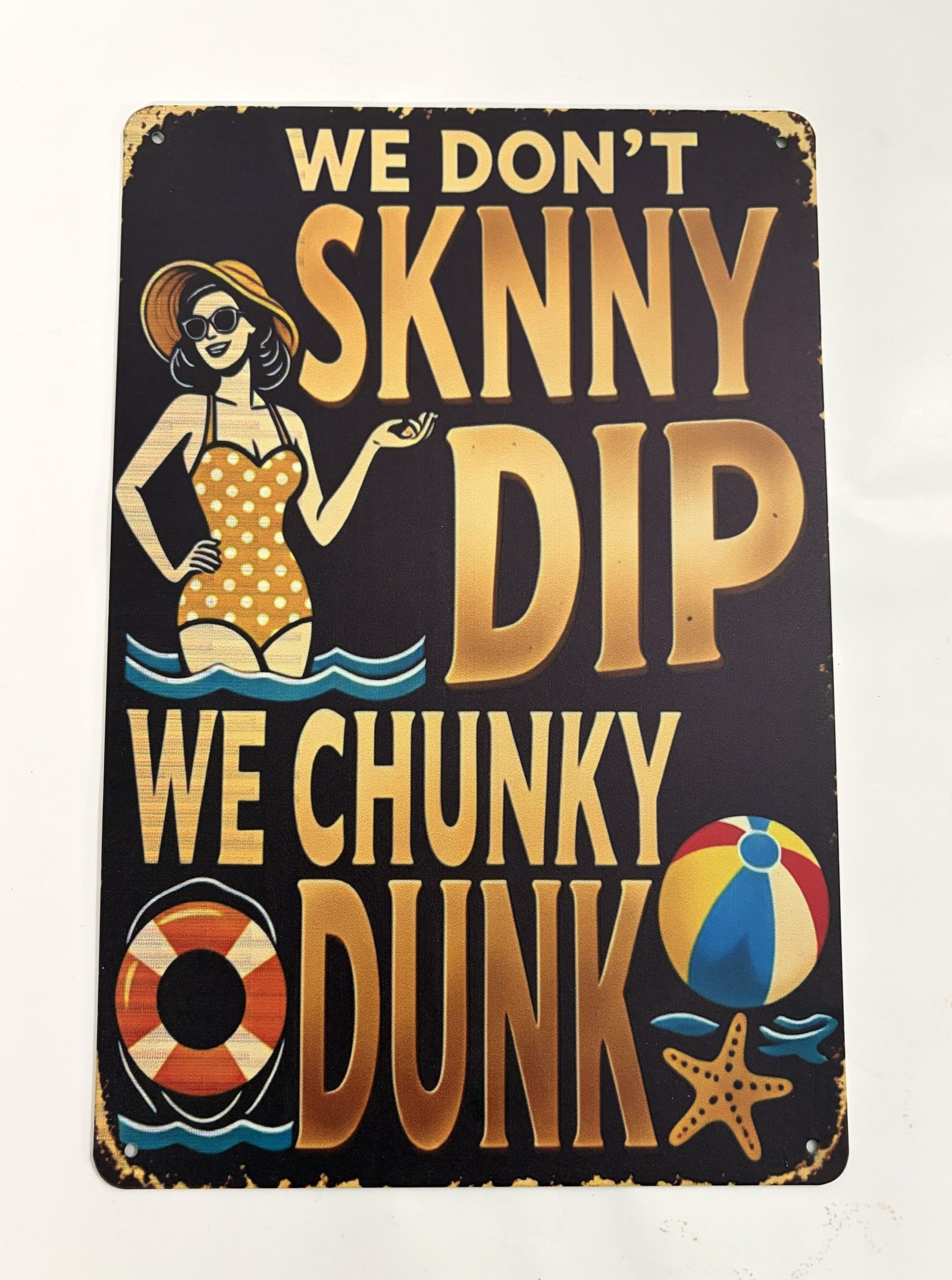 Vintage-style metal pool sign with a woman in a swimsuit and playful text about chunky dunking, featuring beach icons and worn edges for a rustic look.