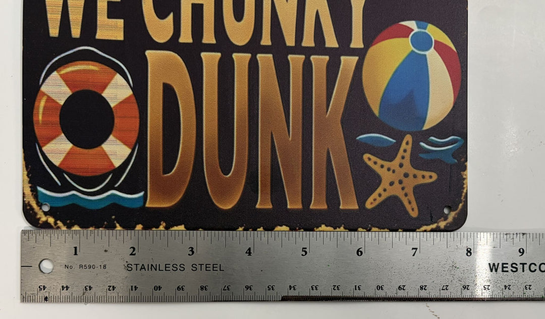 Metal novelty pool sign with humorous misprint text, decorated with a life preserver, beach ball, and starfish, shown with a stainless steel ruler for size reference.