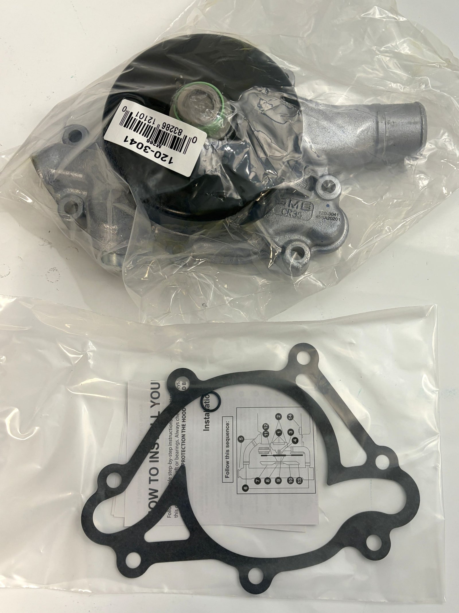 NAPA engine water pump with attached gasket and installation instructions, packaged in clear plastic, suitable for automotive cooling system repair.