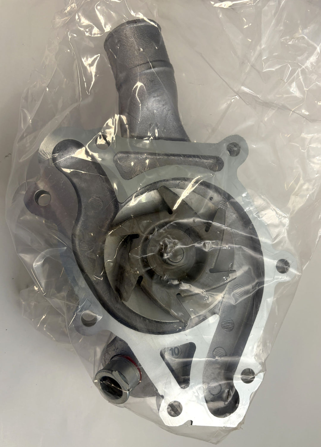NAPA engine water pump with cast aluminum housing, shown inside protective plastic packaging, designed for automotive cooling systems.