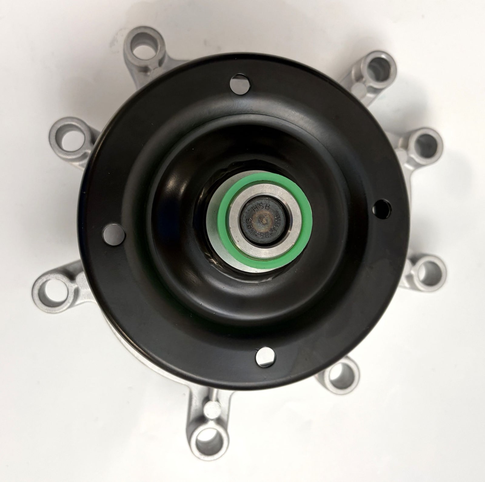 Close-up view of a NAPA engine water pump showing the metal impeller and mounting points, designed for Jeep and Dodge 3.7L and 4.7L engines.