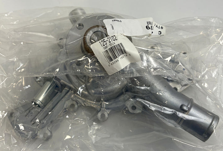 NAPA engine water pump in clear plastic packaging, metal construction with mounting points and a cylindrical outlet, suitable for automotive use.