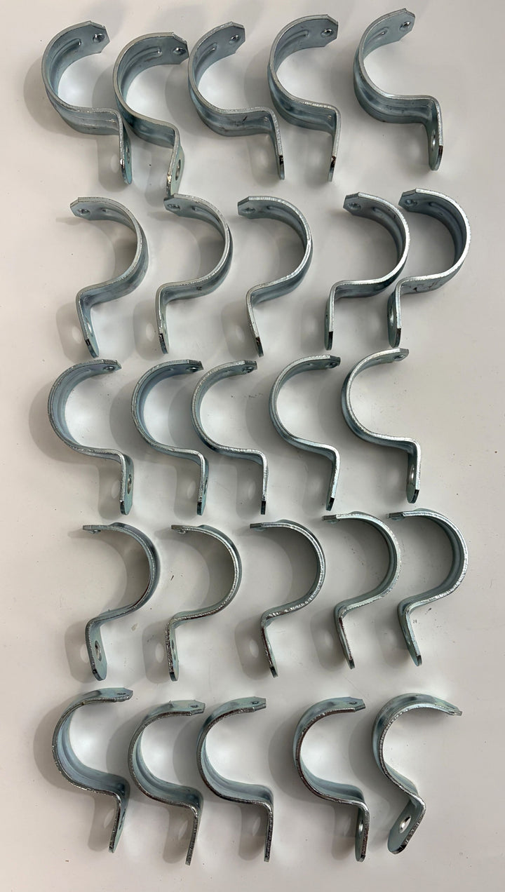 Arlington steel one hole EMT conduit straps arranged in rows for securing one and one quarter inch electrical conduit 25 pack