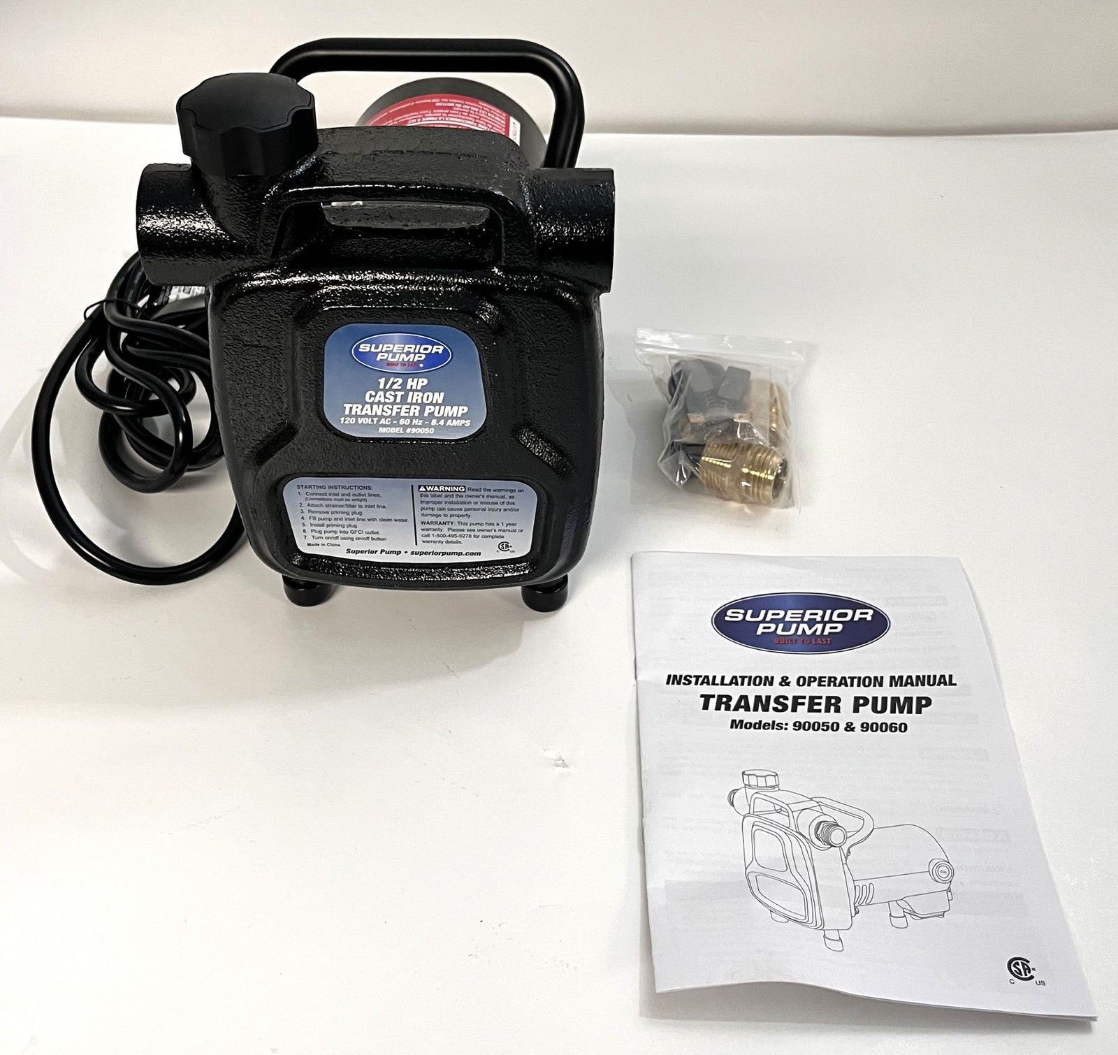 Superior Transfer Pump 90050 with cast iron body, accompanied by an operation and installation manual, and a few small accessories.