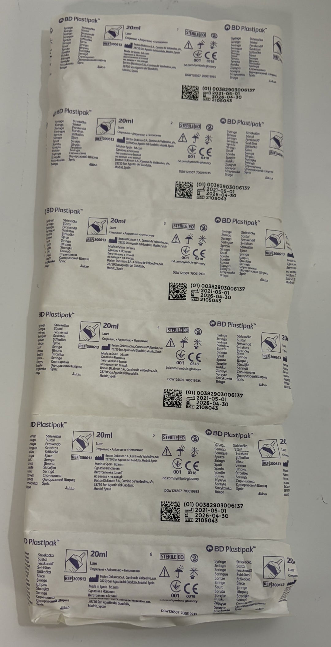 Sealed BD Plastipak 20 mL single use plastic luer syringes in medical packaging with printed product labels and regulatory markings