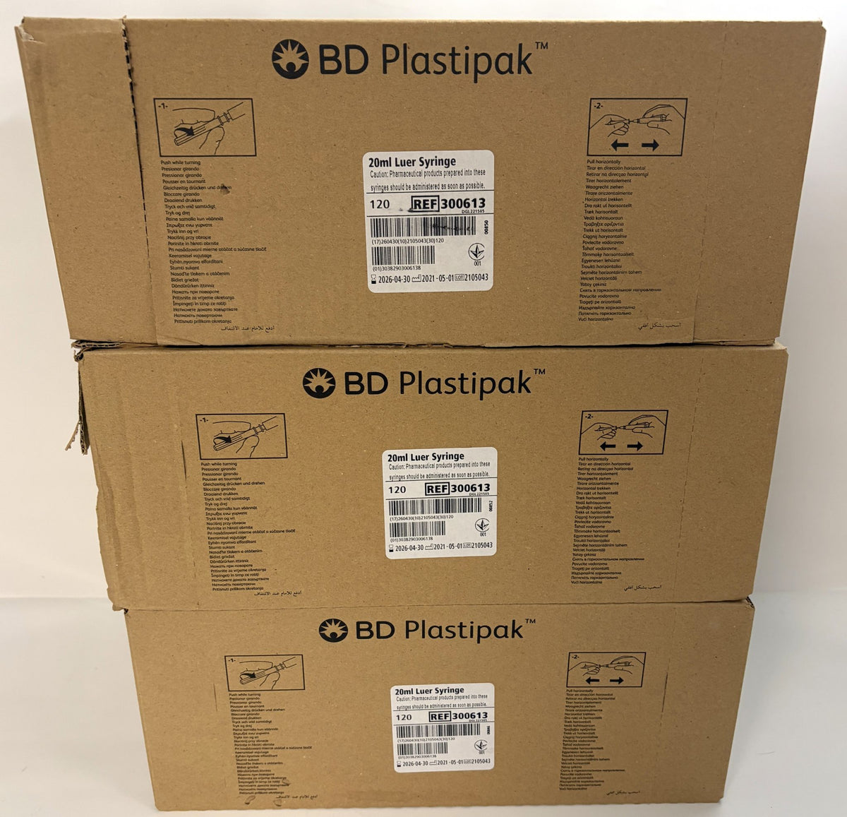 Three stacked brown BD Plastipak boxes labeled 20 mL Luer Syringe, reference 300613, for medical use