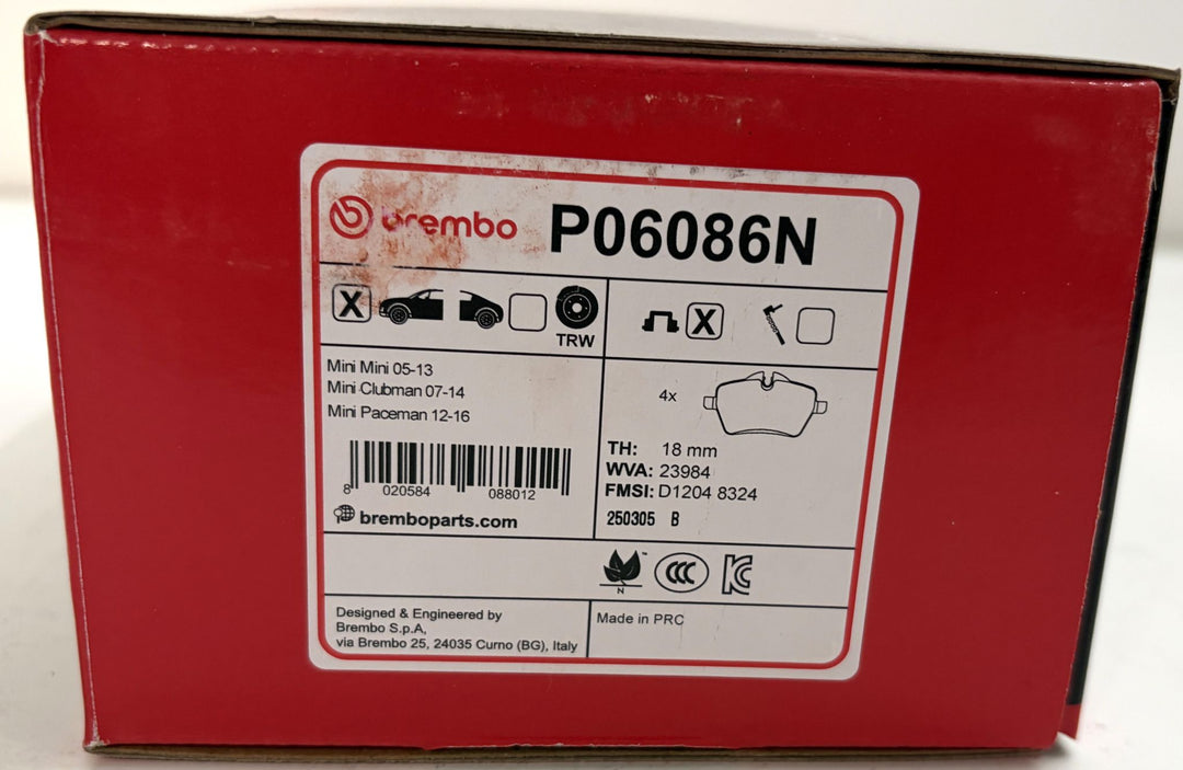 Red Brembo automotive brake pad box labeled P06086N, with Mini model compatibility details and a brake pad illustration.