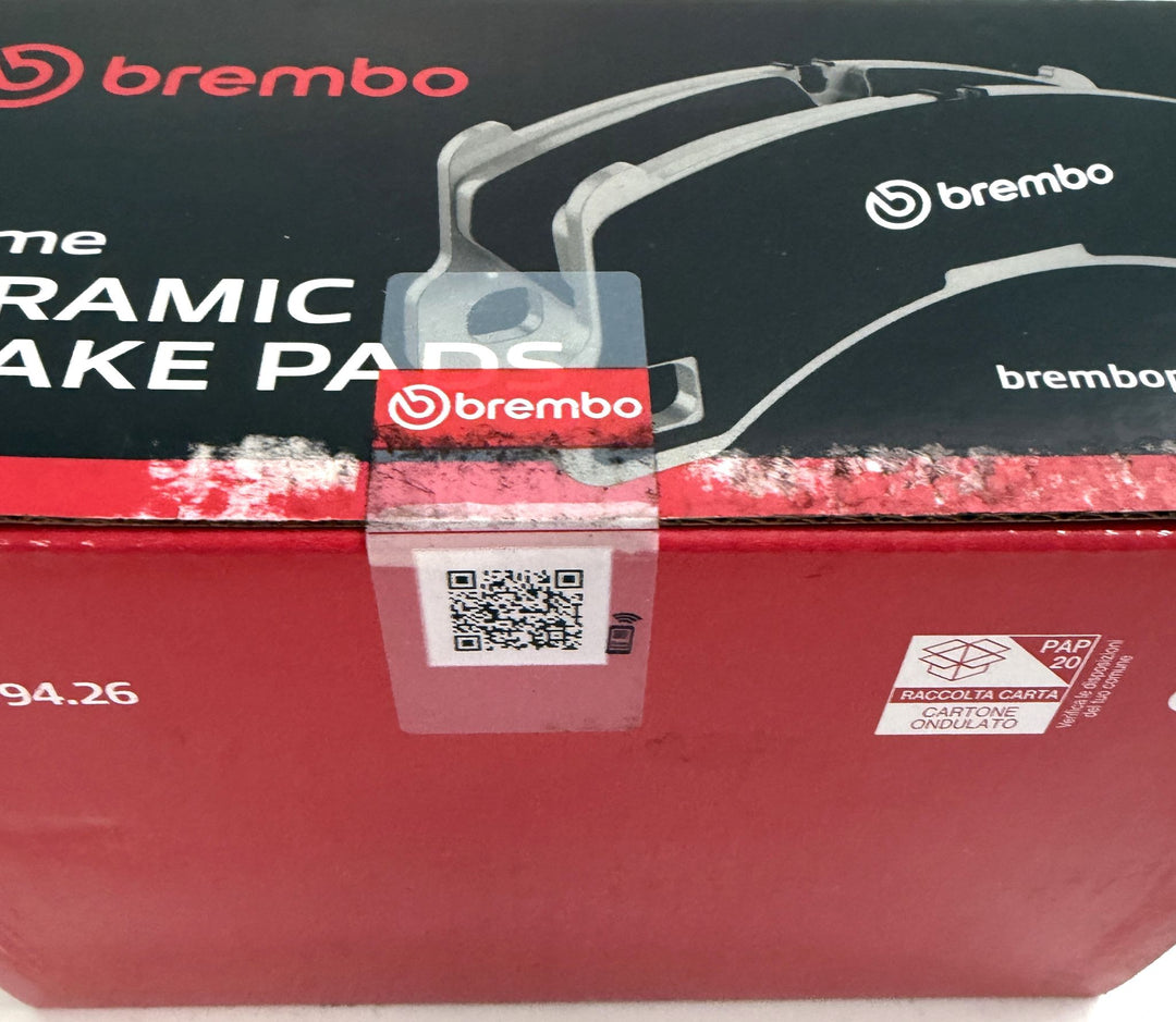 Brembo ceramic brake pad packaging with red and black box design, Brembo logos, QR code, and paper recycling label