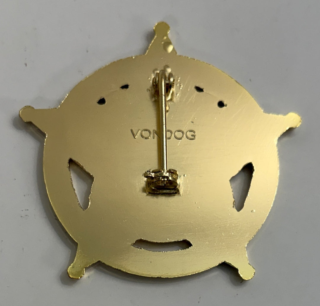 Gold-colored badge with 'Von Dog' branding on a gray background