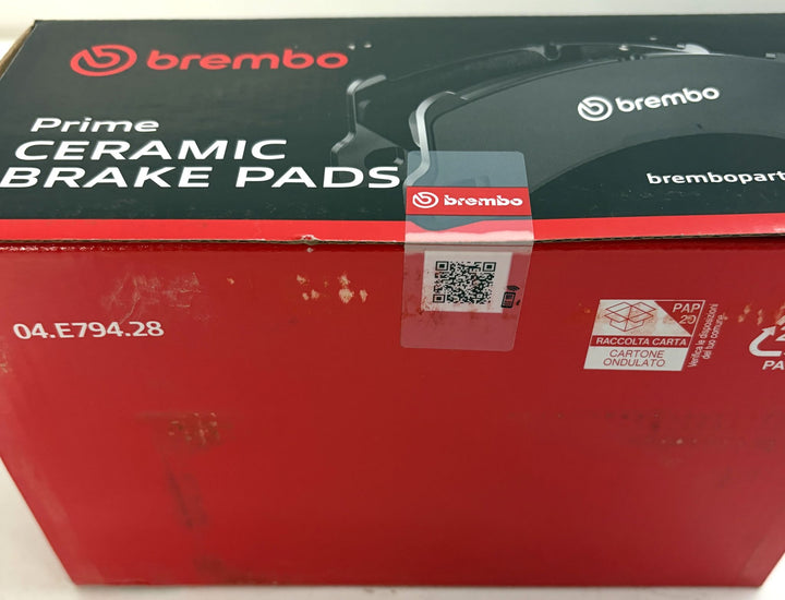 Brembo Prime ceramic brake pads packaging in red and black, labeled part number 04.E794.28, with visible scuffs and QR code label