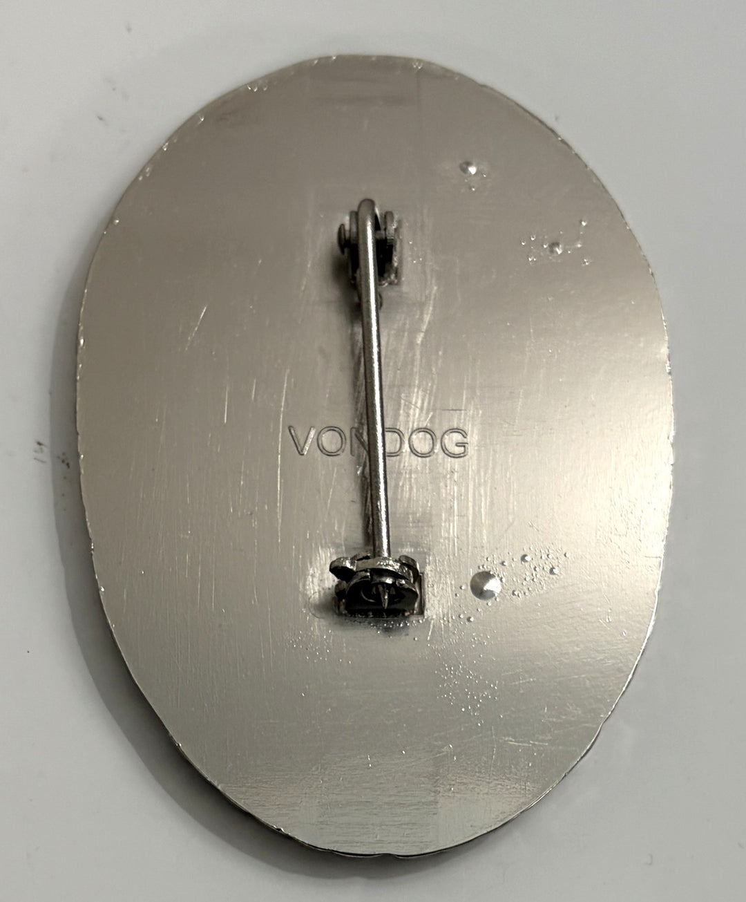 Metallic object with 'VONCOC' branding on a gray background