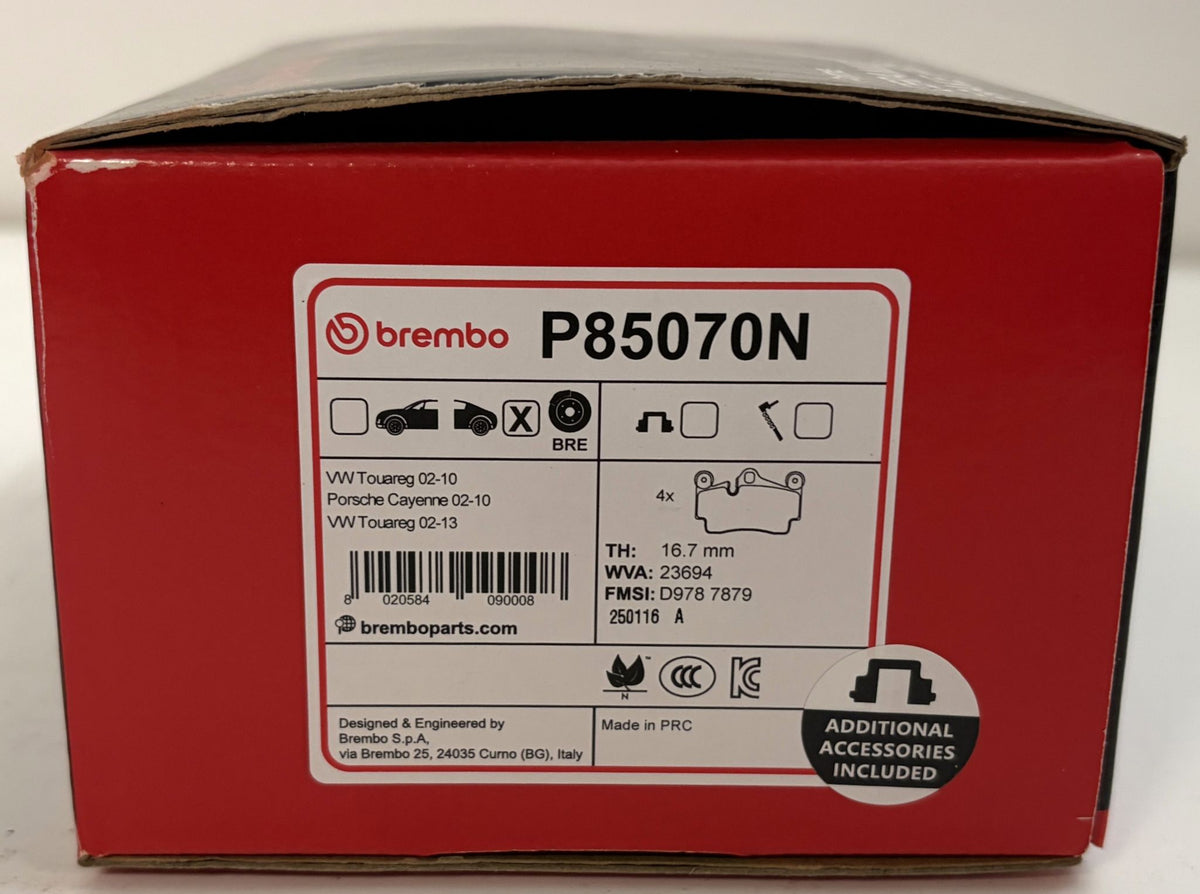 Red Brembo P85070N automotive brake pad box labeled for VW Touareg and Porsche Cayenne applications, with additional accessories included label