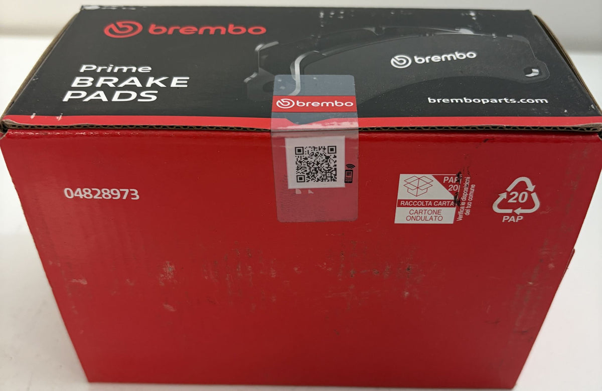 Sealed Brembo Prime automotive brake pad box in red and black packaging, marked G4828973 with QR code and recycling symbols