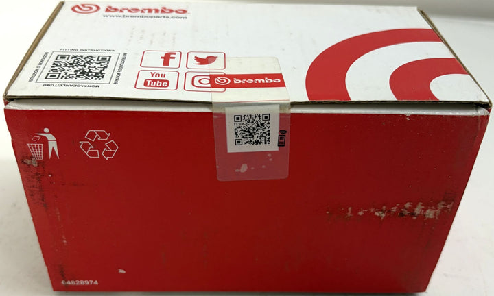 Brembo P56131N ceramic front brake pad box for Nissan Kicks, red and white packaging with factory seal, QR codes, and scuffed surfaces
