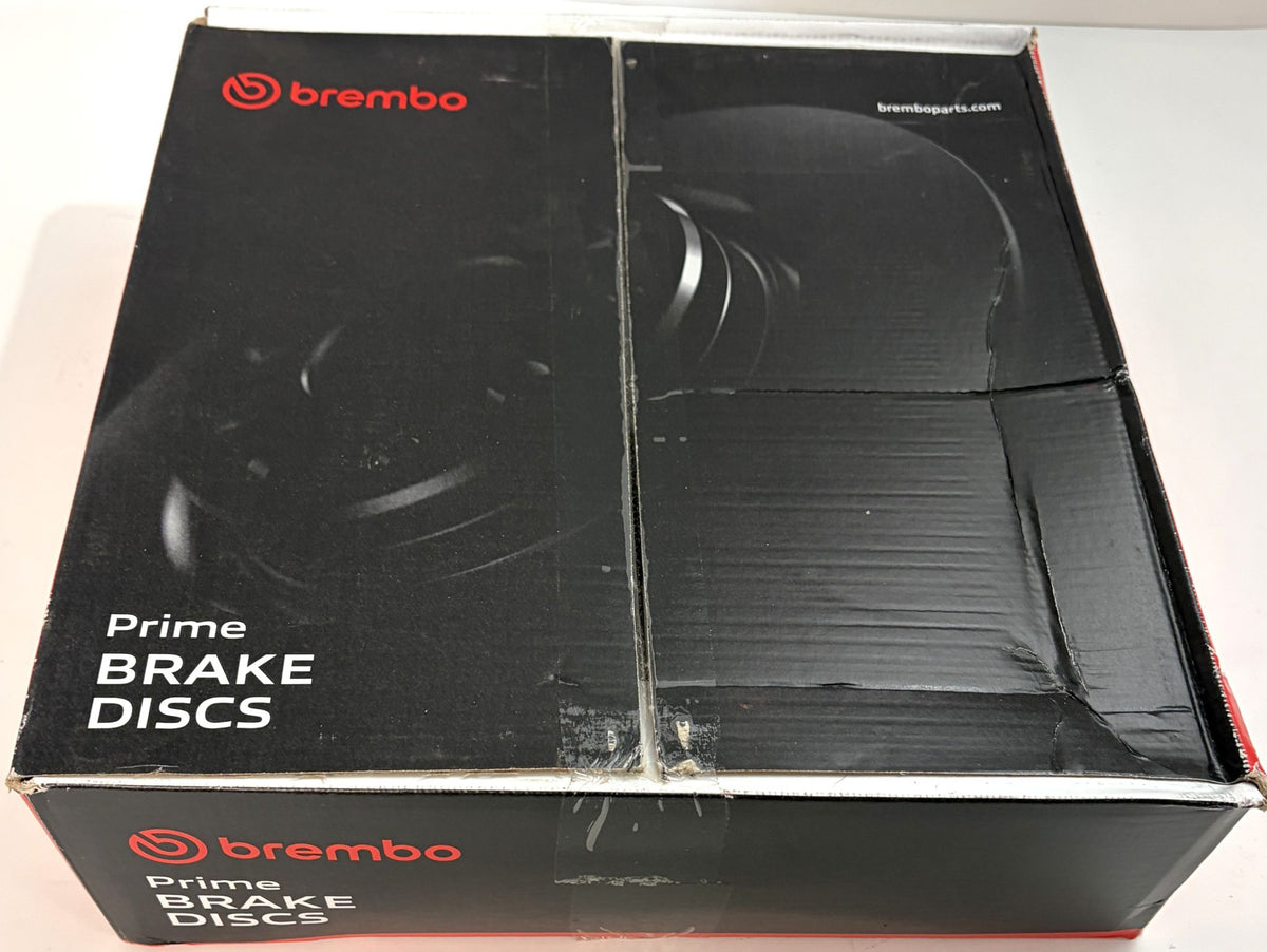 Black Brembo Prime Brake Discs box with red branding and brake rotor graphics on the packaging, shown from above on a light surface