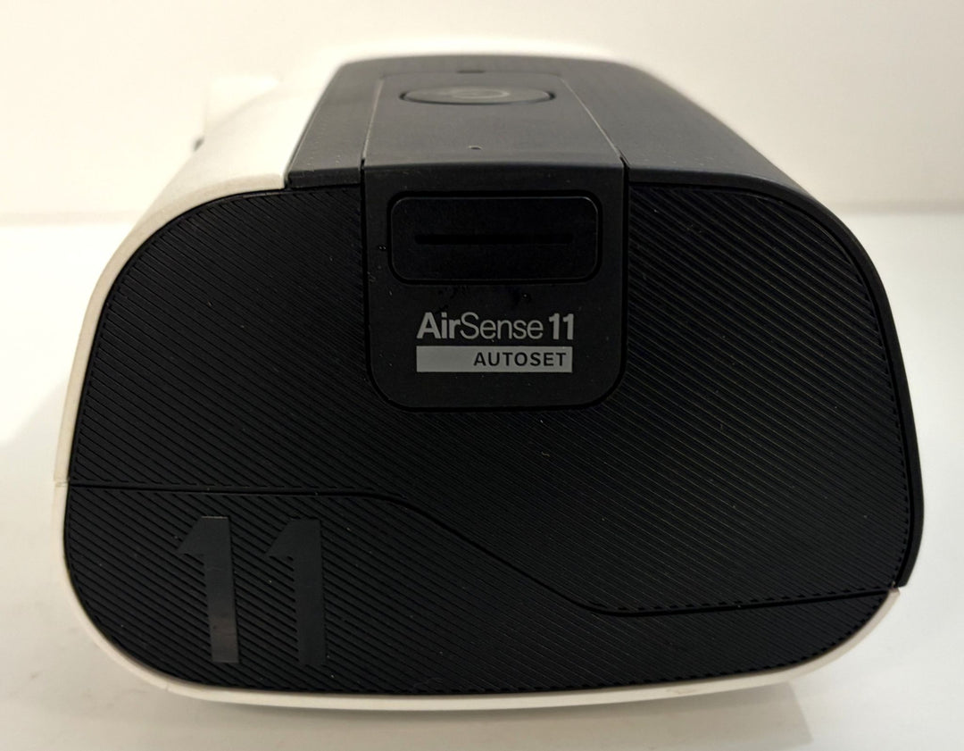 Pre owned Resmed AirSense 11 AutoSet CPAP machine with black textured front and white housing for medical respiratory care