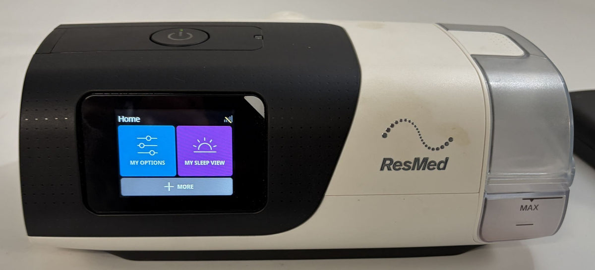 Pre owned Resmed AirSense 11 AutoSet CPAP machine in black and beige with touchscreen display and clear humidifier chamber