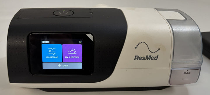 Pre owned Resmed AirSense 11 AutoSet CPAP machine in black and beige with touchscreen display and clear humidifier chamber