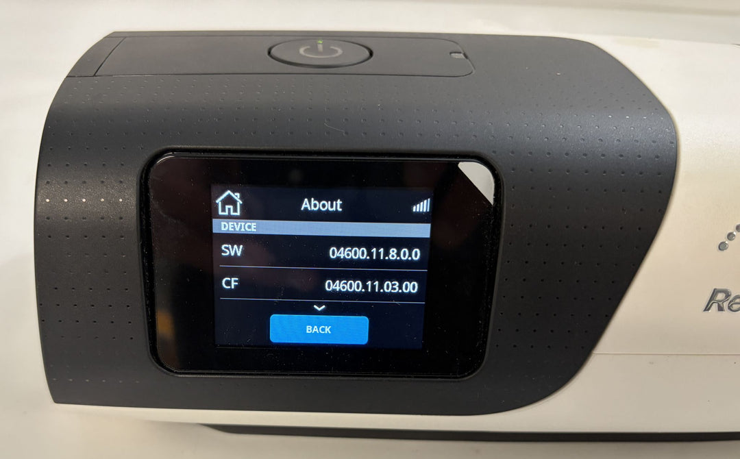 Pre owned ResMed AirSense 11 AutoSet medical CPAP machine with touchscreen About menu and black and white housing