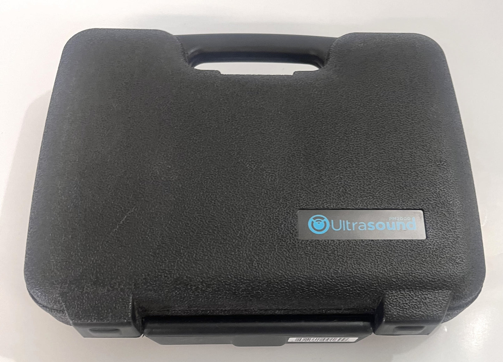 Portable Ultrasound PM 2000 device with AC adapter, gel, and carrying case.