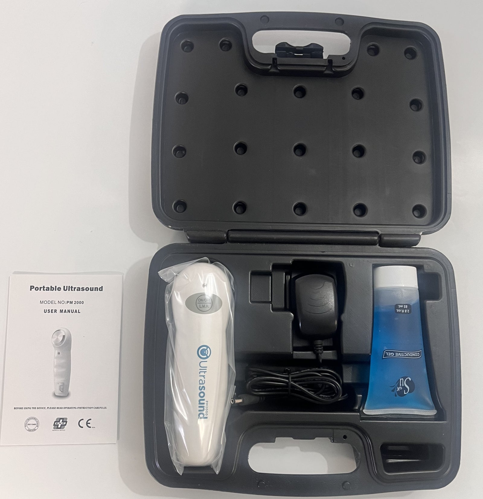 Portable Ultrasound PM 2000 device with AC adapter, gel, and carrying case.