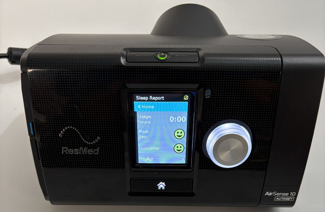 Resmed AirSense 10 AutoSet black CPAP console with illuminated Sleep Report screen and control dial, pre-owned medical equipment