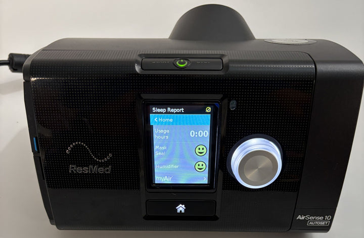 Resmed AirSense 10 AutoSet black CPAP console with illuminated Sleep Report screen and control dial, pre-owned medical equipment