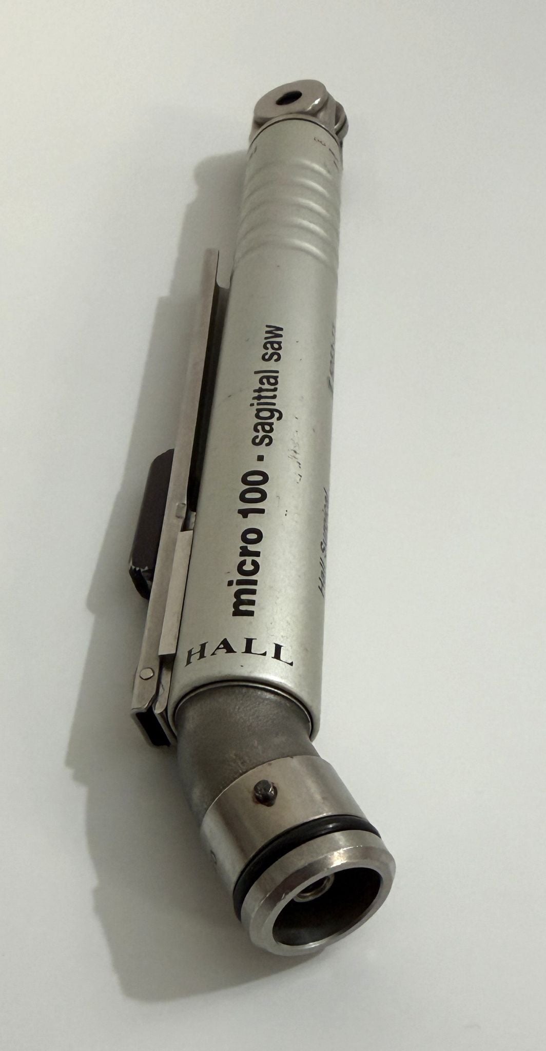 Metal tool with 'micro 100 sagittal saw' branding on a white background