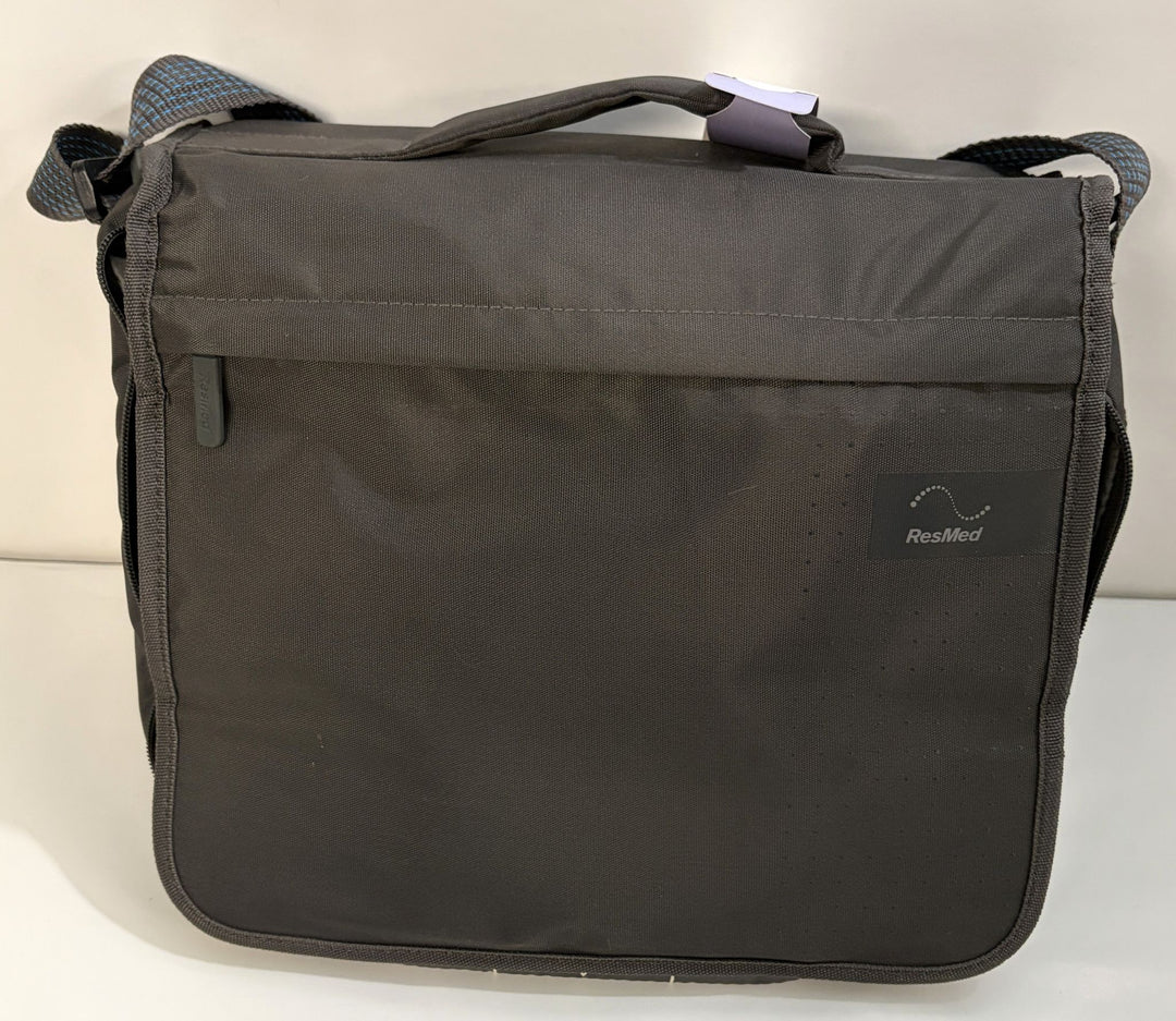 Black ResMed shoulder carrying bag with adjustable strap, front flap pocket, handle, and subtle textured fabric finish.