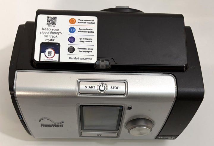 ResMed CPAP machine in black and silver with digital display, control dial, start and stop button, and myAir user guidance label