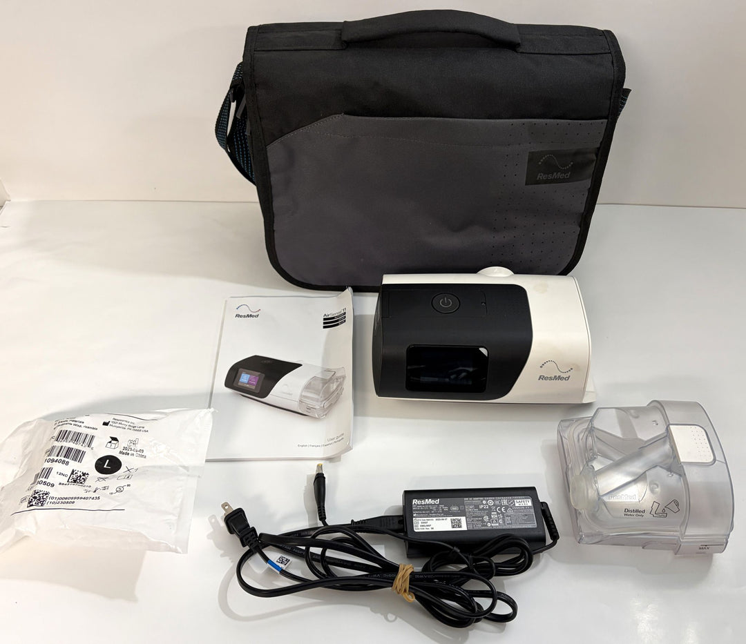 ResMed AirSense 11 AutoSet CPAP machine with carrying case, power adapter, manual, and HumidAir water chamber, pre-owned medical equipment