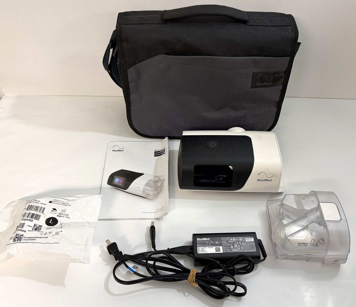 ResMed AirSense 11 AutoSet CPAP machine with carrying case, power adapter, manual, and HumidAir water chamber, pre-owned medical equipment