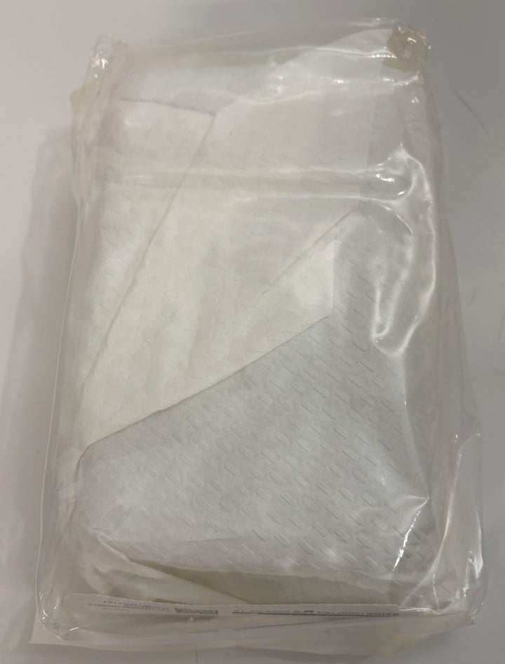 Sealed clear plastic package containing folded white textile material with a soft, layered appearance.