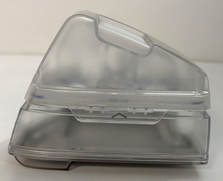 Clear plastic hinged storage container with a translucent lid, raised handle, and rectangular base on a white background