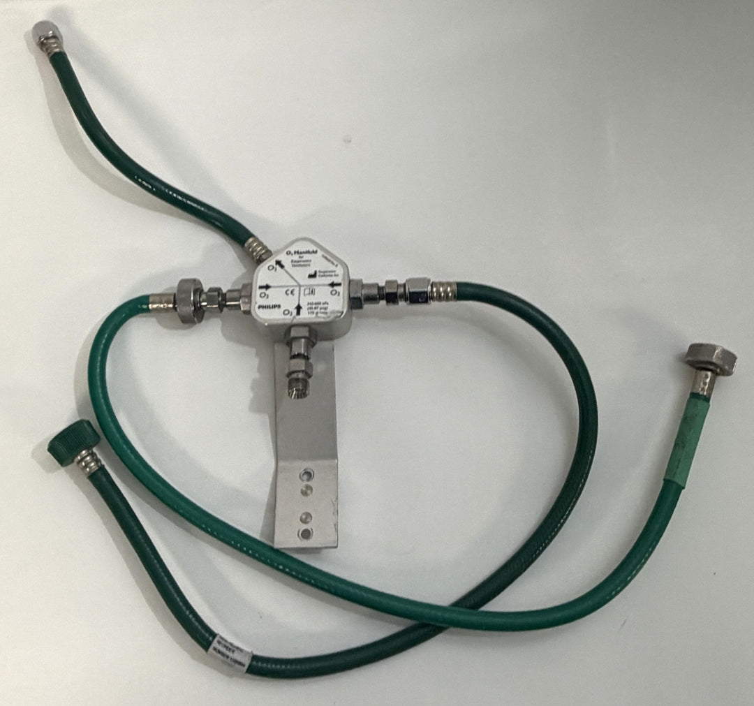 Philips Respironics O2 manifold assembly 1109668 Rev B with three attached green oxygen hoses, pre-owned medical equipment
