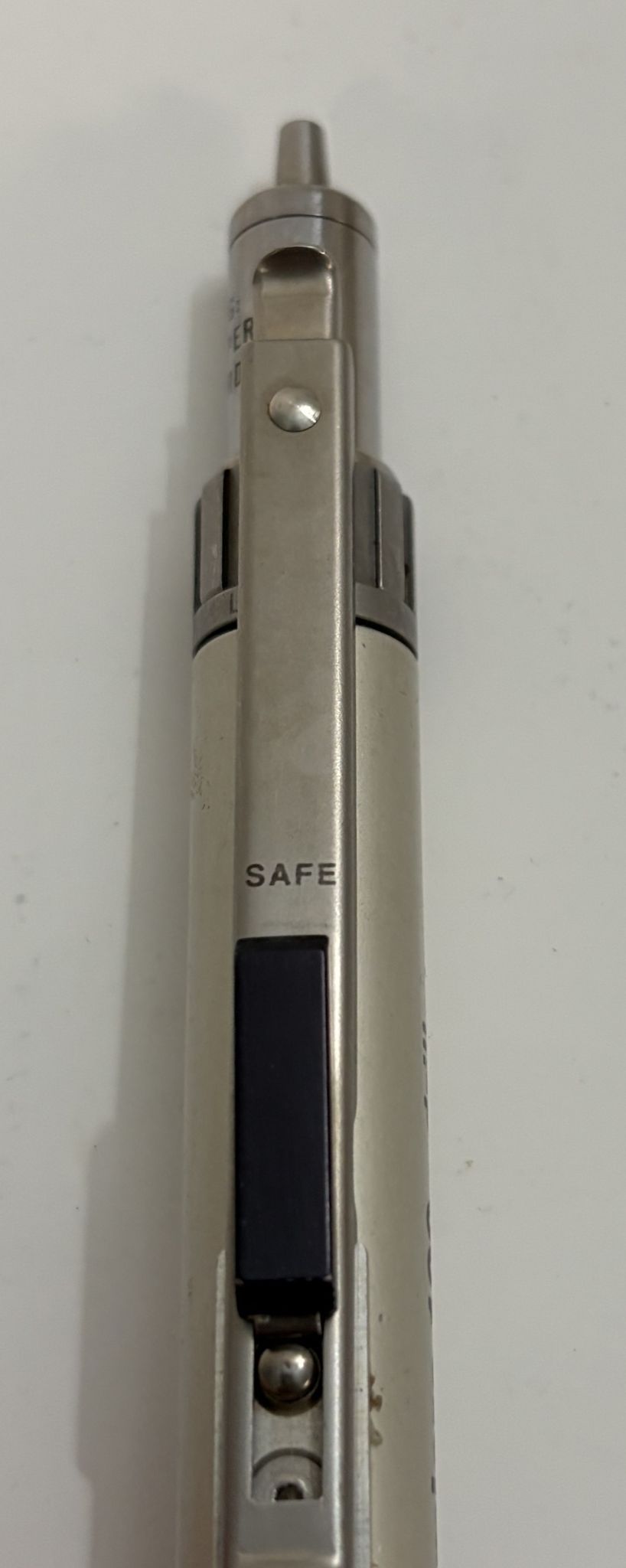 Metallic pen with 'SAFE' label on a white background
