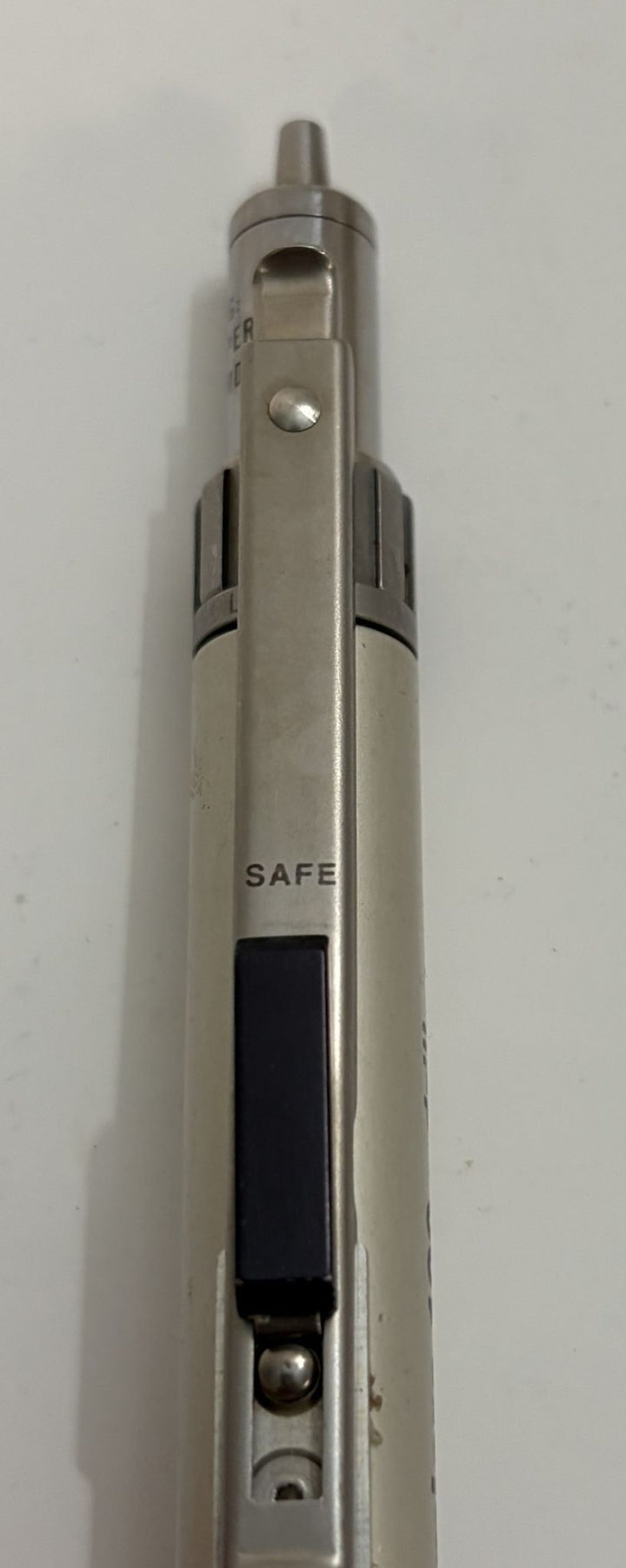Metallic pen with 'SAFE' label on a white background