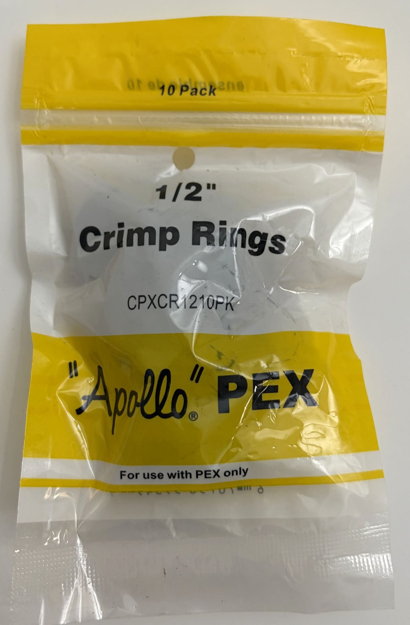 Pack of Apollo PEX crimp rings with yellow and white packaging.