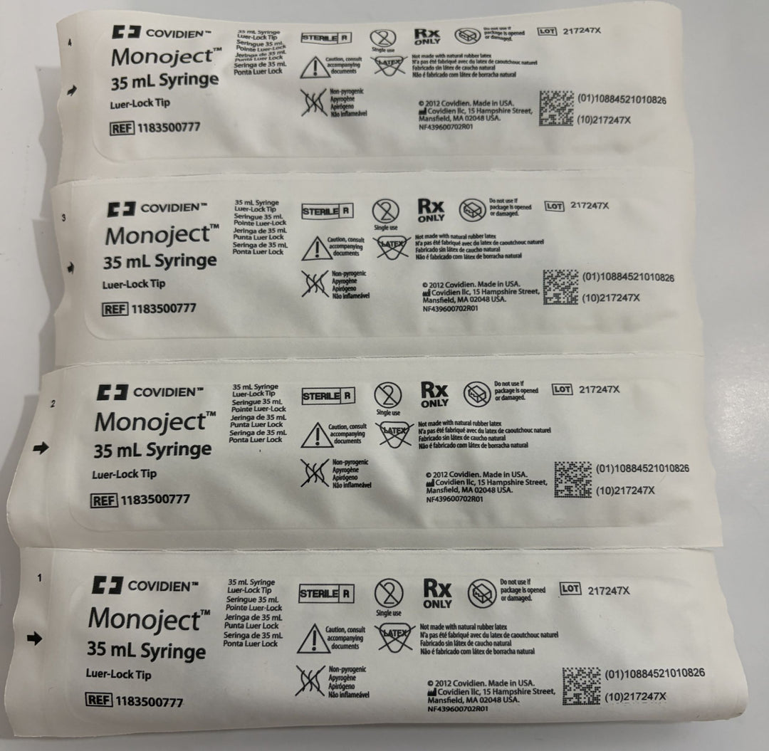 Four individually wrapped sterile 35 mL Luer Lock syringes by Covidien, showing packaging labels with usage instructions and medical symbols against a plain background.